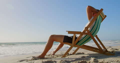 Relaxed Man Enjoying Seaside on Beach Lounger