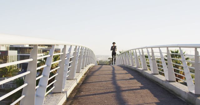 Woman Running on Pedestrian Bridge during Sunset - Download Free Stock Images Pikwizard.com