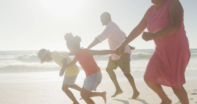 Happy Family Running Together on Sunny Beach - Download Free Stock Images Pikwizard.com