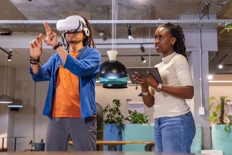 African American Coworkers Testing VR Headset in Modern Open-Plan Office Collaboration