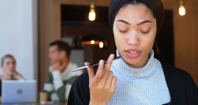 Young Woman Using Smartphone Voice Command in Coffee Shop - Download Free Stock Images Pikwizard.com