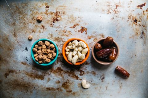 Assortment of nuts and dates on rustic surface