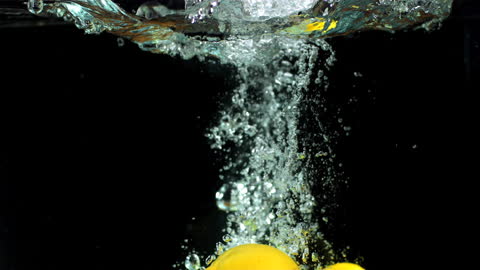 Lemons and Limes Splashing Dramatically Underwater