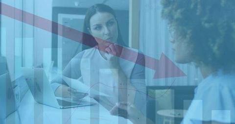 Midadult woman listening during business meeting with downtrend charts and data overlay