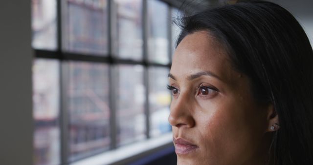 Woman Gazing through Window in Office Setting - Download Free Stock Images Pikwizard.com