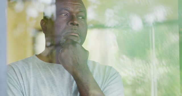 Pensive Middle-Aged Man Looking Through Window Contemplating - Download Free Stock Images Pikwizard.com