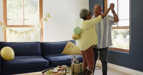 Senior Couple Joyfully Dancing While Preparing for a Celebration