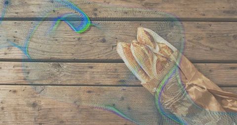 Rustic baguettes in brown paper bag on weathered wood with colorful mesh overlay