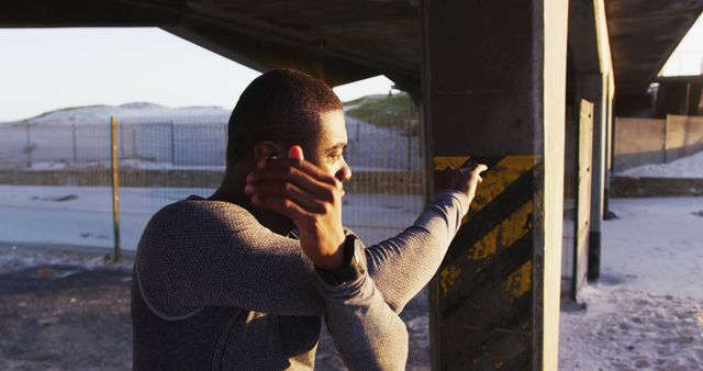 Focused Athlete Stretching Outdoors Under a Bridge Before Workout - Download Free Stock Images Pikwizard.com