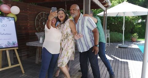 Happy Seniors Taking a Selfie at Outdoor Celebration