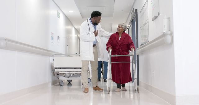 Doctor supporting an elderly patient using a walker, walking together in a hospital corridor. Scene emphasizing healthcare, rehabilitation, and compassionate caregiving. Suitable for websites, brochures, and articles focusing on elder care, medical services, and patient recovery.