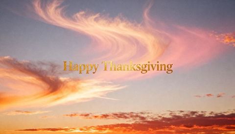 Glowing Gold Happy Thanksgiving Text Floating Over Pastel Sunset Sky with Wispy Clouds