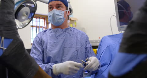 Veterinary Surgeon Operating in Theater with Surgical Instruments