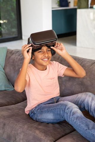 Boy Enjoys VR Experience on Comfortable Living Room Sofa
