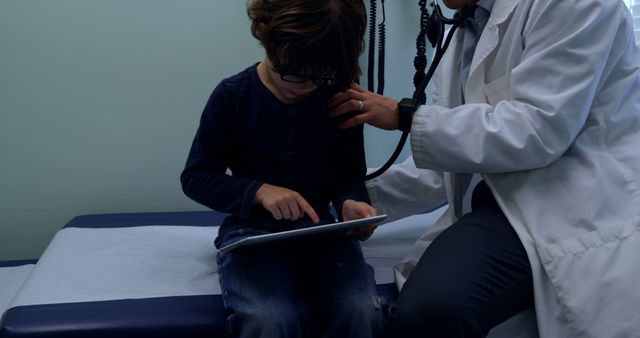 Pediatrician Examining Child Using Tablet in Medical Office - Download Free Stock Images Pikwizard.com