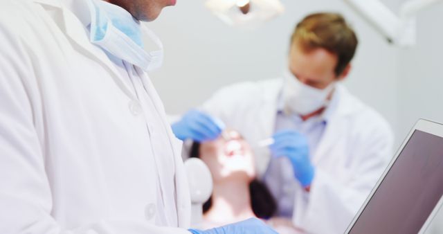 Dentists Treating Patient in Clinic with Modern Technology - Download Free Stock Images Pikwizard.com