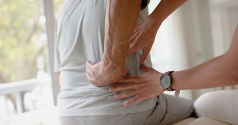 Senior Man Receiving Lower Back Physiotherapy
