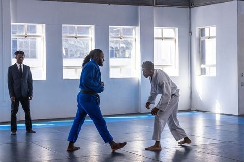 Martial Arts Coach and Students Sparring on Mats in Training Room