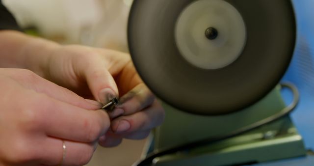 Close-Up of Hands Sharpening Tool on Bench Grinder - Download Free Stock Images Pikwizard.com