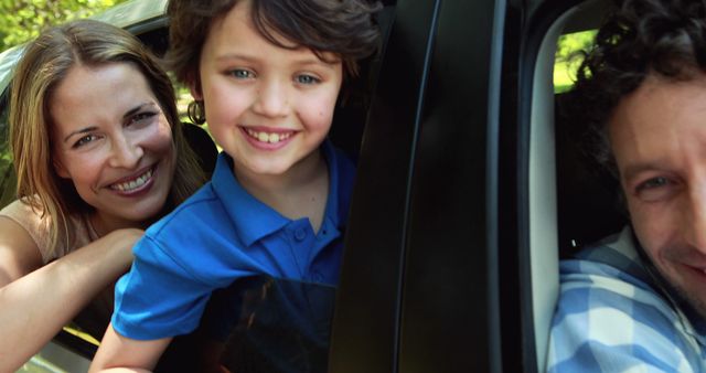 Happy Family Enjoying Road Trip with Smiling Boy Leaning Out Car Window - Download Free Stock Images Pikwizard.com