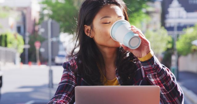 Young Woman Drinking Coffee while Working on Laptop Outdoors - Download Free Stock Images Pikwizard.com