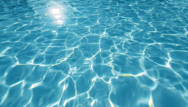 Shimmering pool water with sunlight reflections