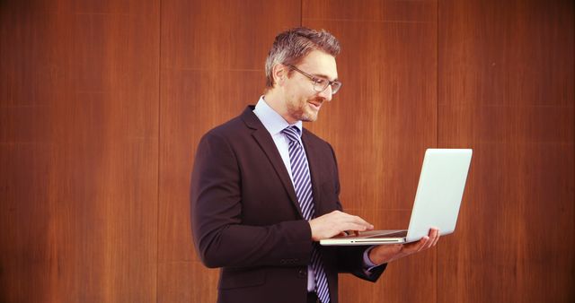 Confident Businessman Using Laptop in Office - Download Free Stock Images Pikwizard.com