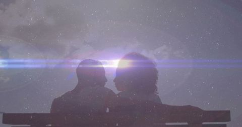 Silhouetted Couple Under Starry Sky Encompassed by Cosmic Glow