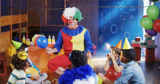 A clown entertains a diverse group of children at a birthday party, with copy space. Balloons and party hats add to the festive atmosphere as the kids engage with the performer.