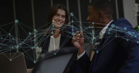 Colleagues Collaborating with Futuristic Network Interface