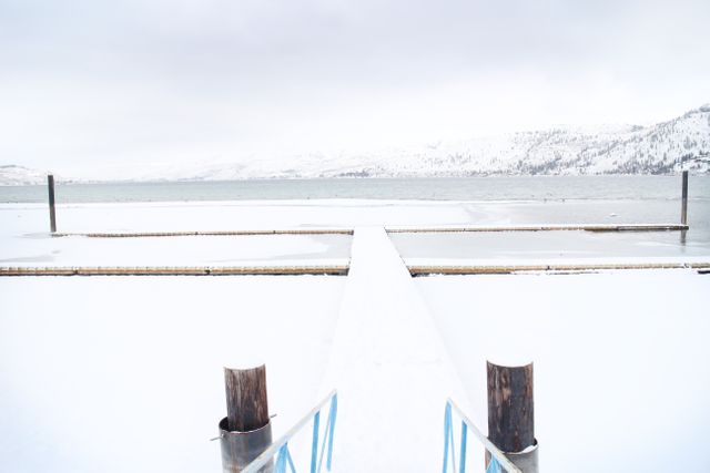 Snowy Pier Extending Into Frozen Lake in Winter Landscape - Download Free Stock Images Pikwizard.com