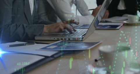 Business Professionals Analyzing Financial Data with Laptops