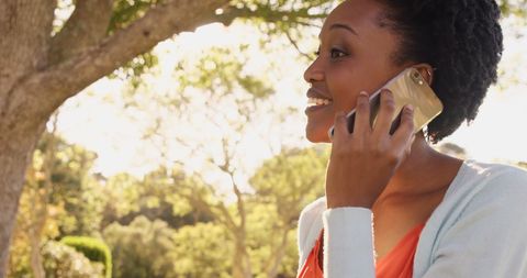 Woman engaging in phone conversation in peaceful park