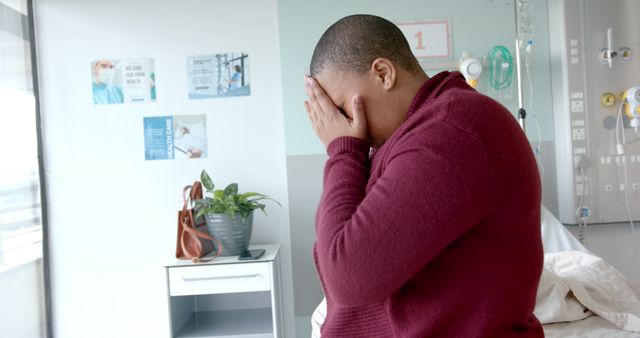 Sad african american woman covering her face in hospital room - Download Free Stock Photos Pikwizard.com