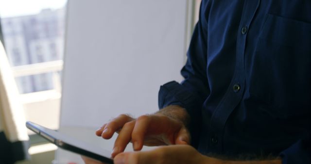 Businessman Using Tablet in Office with City View - Download Free Stock Images Pikwizard.com