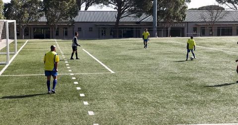 Soccer Players in Action on Summer Field during Training Session
