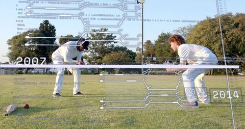 Crouching cricketers with analytics overlay at crease for coaching and match analysis
