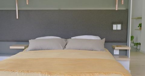 Minimalist Bedroom with Copper Pendant Lights and Beige Duvet