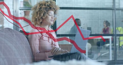 Businesswoman Analyzing Market Trends on Laptop in Modern Office