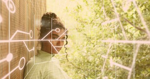 Woman in high-neck top with augmented reality circuit overlay, sunlit greenery portrait