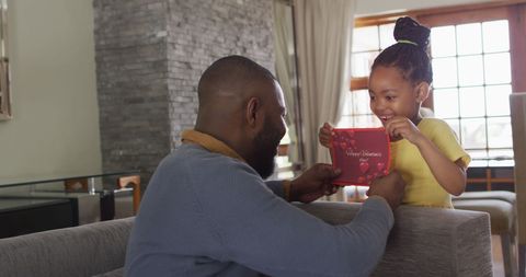 Joyful Daughter Giving Valentine's Gift to Delighted Father - Download Free Stock Images Pikwizard.com