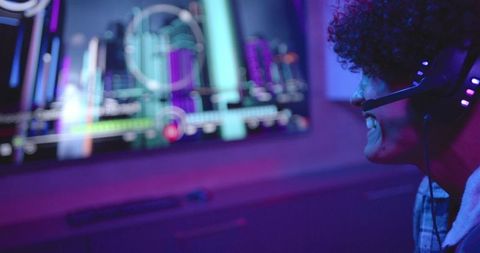 Focused Gamer Communicating via Headset in Dimly Lit Room