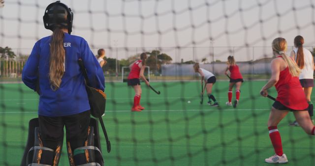 Women's Field Hockey Game on Green Turf at Dusk - Download Free Stock Images Pikwizard.com