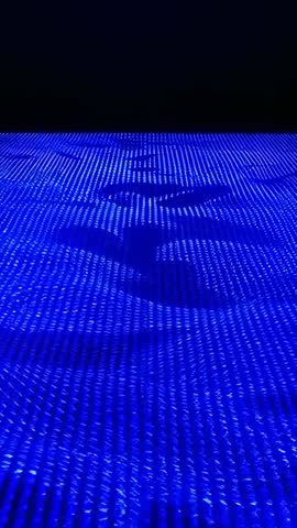 Vertical LED Floor Waves Flowing Toward Horizon in Neon Blue Grid — Futuristic Tech Demo