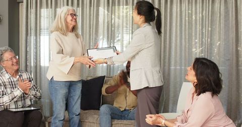 Diverse group therapy session celebrating achievement