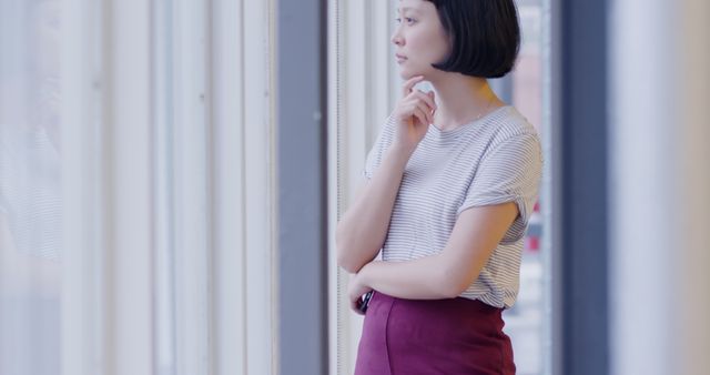 Pensive Woman Looking Out Window in Modern Office - Download Free Stock Images Pikwizard.com