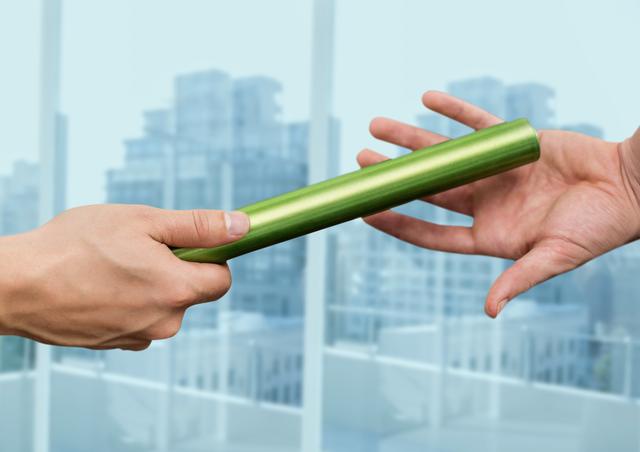 Close-up of hands passing the baton in office - Download Free Stock Photos Pikwizard.com