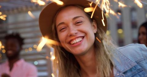 Joyful Woman Celebrating with Sparklers on Rooftop
