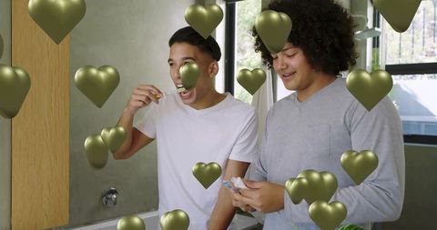 Roommates brushing teeth together in bright bathroom with floating gold hearts