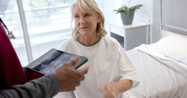 Senior Woman in Hospital Gown Consulted by Doctor with Tablet - Download Free Stock Images Pikwizard.com